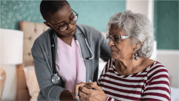 A female nurse cares for a woman with dementia