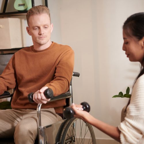 caregiver-showing-exercise-to-patient